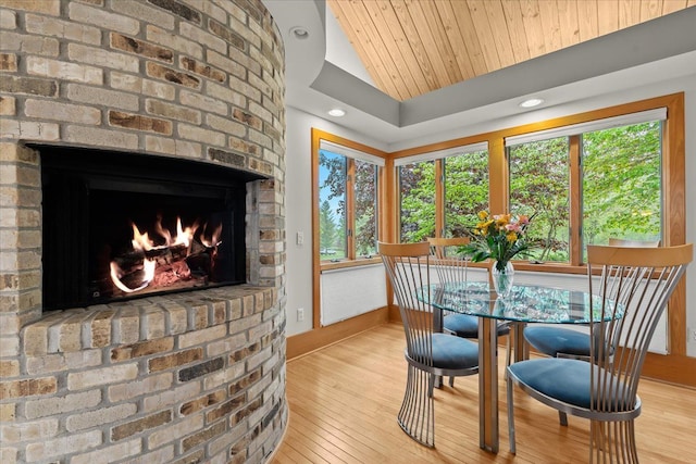 5226 Pleasant Hill Dr, Fenton, MI 48430 - dining space featuring wood finished floors, vaulted ceiling, baseboards, a fireplace, and recessed lighting