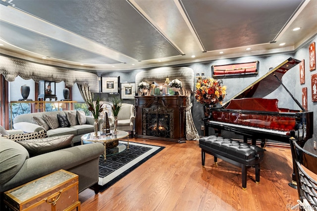 7310 Sandy Creek Ln, Bloomfield Hills, MI 48301 - living area featuring a raised ceiling, wood finished floors, and a lit fireplace