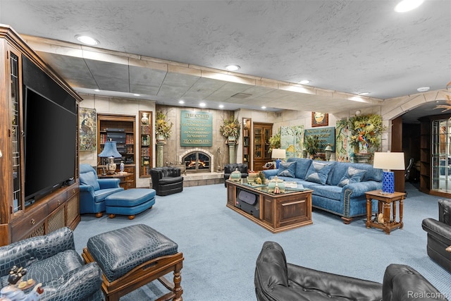 7310 Sandy Creek Ln, Bloomfield Hills, MI 48301 - carpeted living area featuring a warm lit fireplace, arched walkways, and recessed lighting