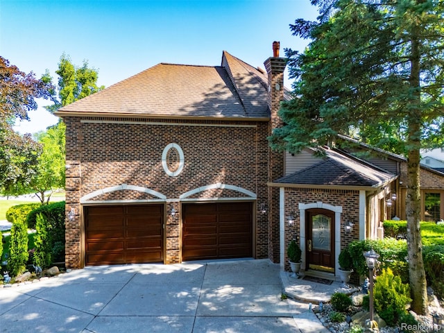 7310 Sandy Creek Ln, Bloomfield Hills, MI 48301 - view of front of house with a shingled roof, brick siding, driveway, an attached garage, and a chimney