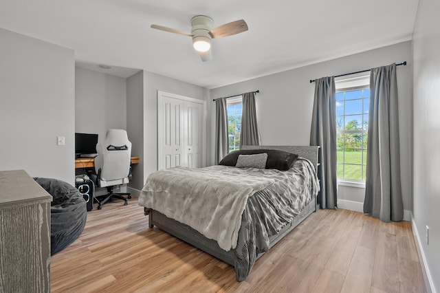15974 Rustic Ln S, Vicksburg, MI 49097 - bedroom with light wood-type flooring, baseboards, an office area, a closet, and ceiling fan