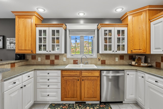 15974 Rustic Ln S, Vicksburg, MI 49097 - kitchen featuring dishwasher, a sink, decorative backsplash, glass insert cabinets, and light tile patterned floors