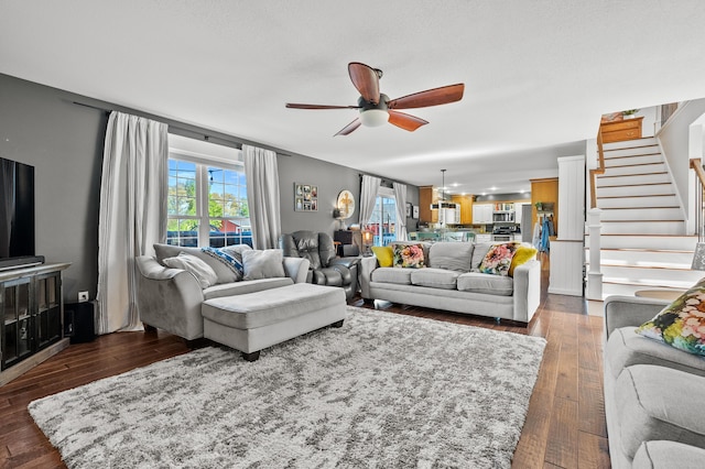 15974 Rustic Ln S, Vicksburg, MI 49097 - living area with ceiling fan, stairs, and dark wood-style floors