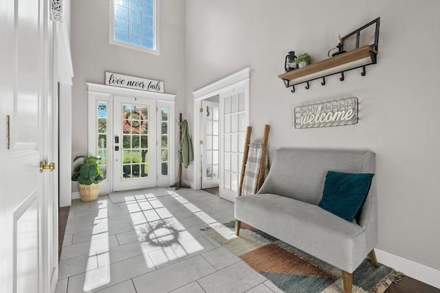 15974 Rustic Ln S, Vicksburg, MI 49097 - sitting room featuring a towering ceiling, tile patterned flooring, and baseboards