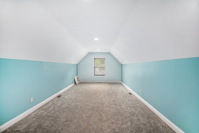 bonus room featuring vaulted ceiling, baseboards, carpet, and recessed lighting