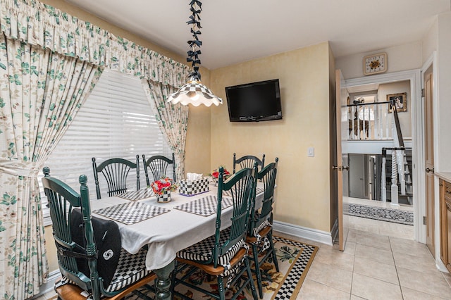 dining area with baseboards and tile patterned floors