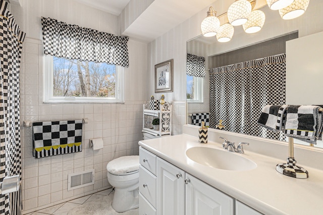 bathroom with toilet, tile walls, and vanity