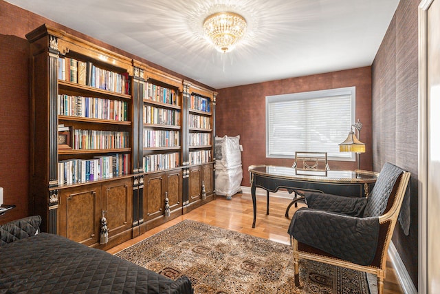 office area with wood finished floors and a chandelier