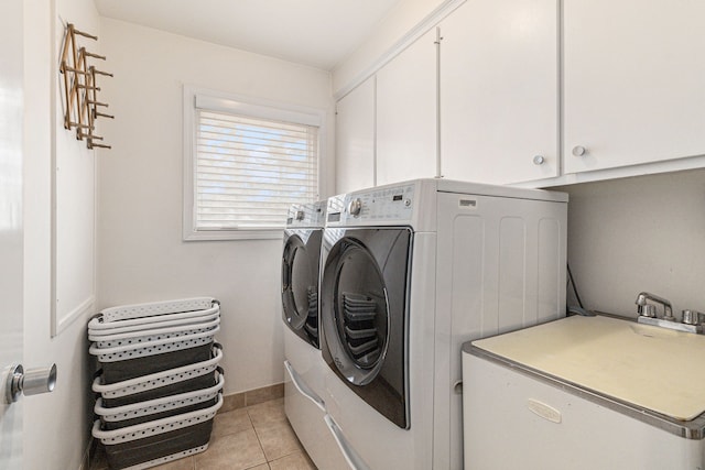 clothes washing area with cabinet space, independent washer and dryer, and light tile patterned floors