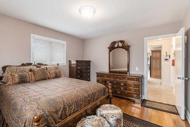 bedroom featuring wood finished floors and baseboards