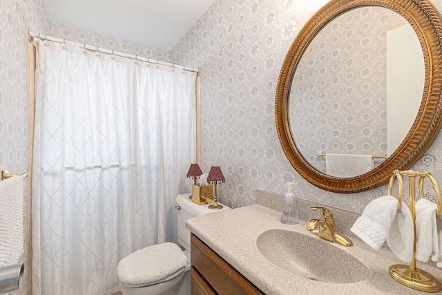 bathroom with vanity, toilet, wallpapered walls, and a shower with curtain