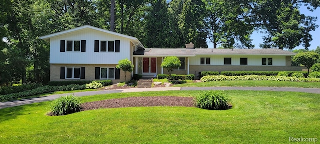 4678 Brightmore Rd, Bloomfield Hills, MI 48302 - split level home with a front lawn, brick siding, and asphalt driveway