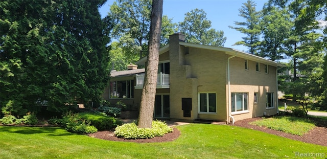 4678 Brightmore Rd, Bloomfield Hills, MI 48302 - rear view of house with a chimney, a yard, and a balcony