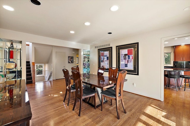 dining area featuring light wood-style floors, recessed lighting, and baseboards