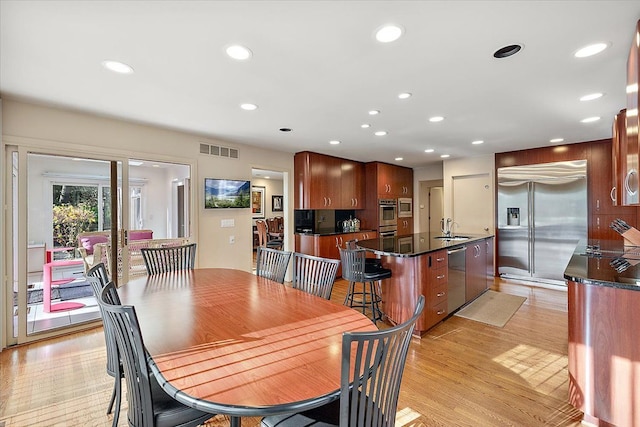 dining area with recessed lighting and light wood-type flooring