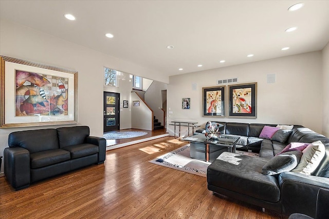 living room with wood finished floors, recessed lighting, stairs, and baseboards