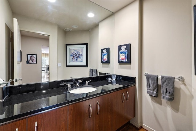 bathroom featuring double vanity and recessed lighting