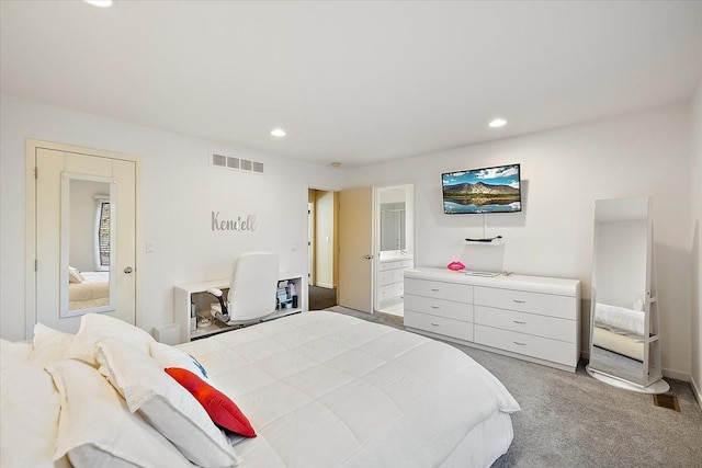 carpeted bedroom featuring recessed lighting and ensuite bath