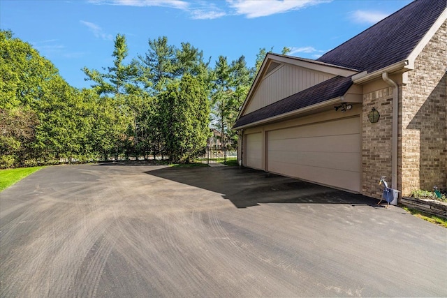 view of property exterior with brick siding and roof with shingles