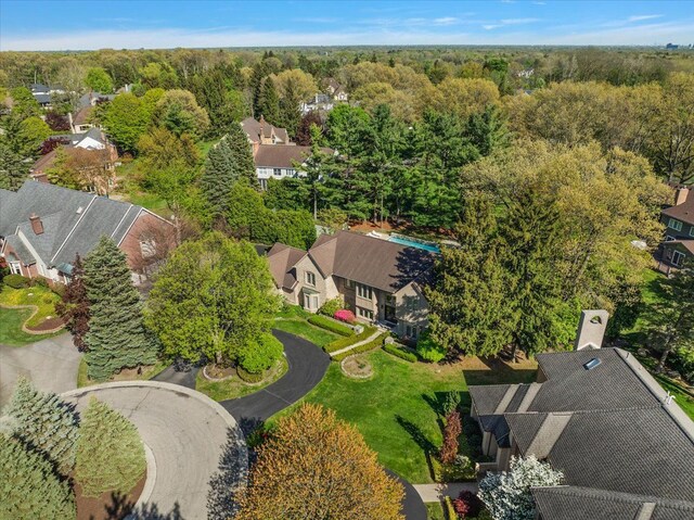 aerial view of residential area featuring a forest