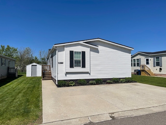 view of side of property featuring a storage shed, an outdoor structure, and a yard