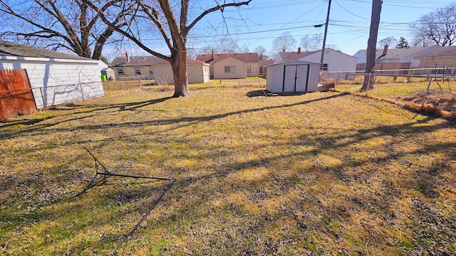 26620 Academy St, Roseville, MI 48066 - view of yard featuring a storage unit, a residential view, and an outbuilding