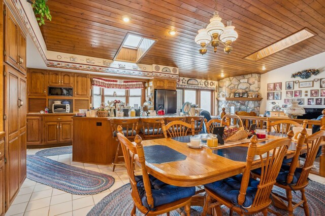 6125 Alber Rd, Saline, MI 48176 - dining space with a skylight, wooden ceiling, a chandelier, and light tile patterned floors