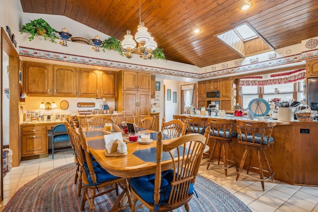 6125 Alber Rd, Saline, MI 48176 - dining area with wooden ceiling, light tile patterned floors, a skylight, a chandelier, and lofted ceiling