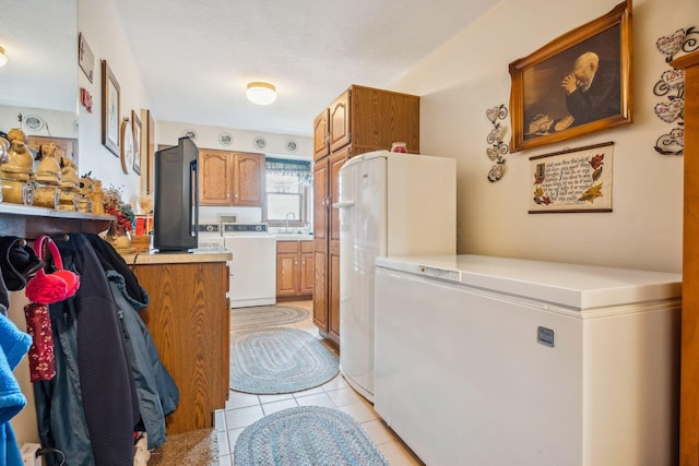 6125 Alber Rd, Saline, MI 48176 - laundry area with light tile patterned floors, cabinet space, and washing machine and dryer
