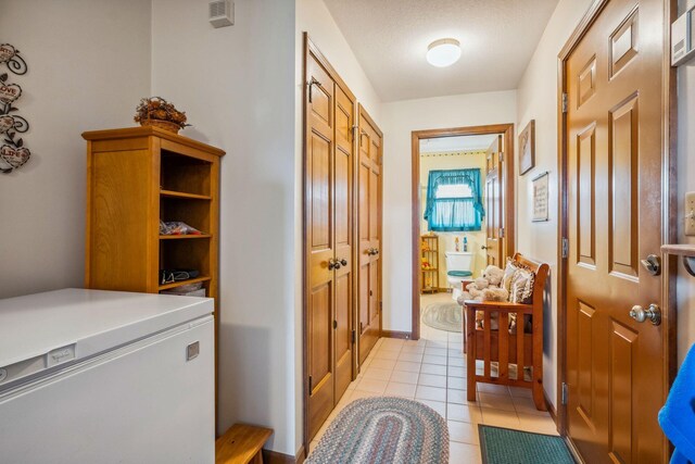 6125 Alber Rd, Saline, MI 48176 - doorway to outside with light tile patterned floors and baseboards