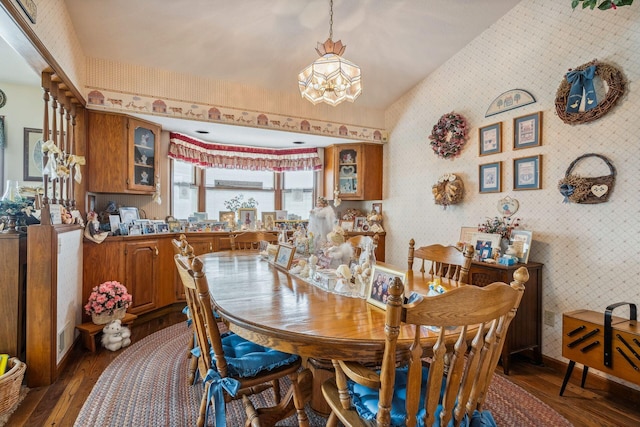 6125 Alber Rd, Saline, MI 48176 - dining room with dark wood-style flooring, a chandelier, wallpapered walls, and lofted ceiling
