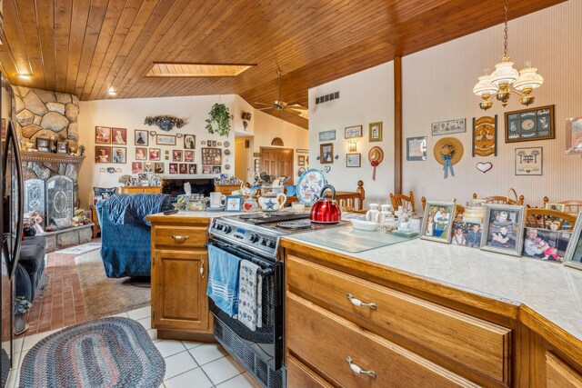 6125 Alber Rd, Saline, MI 48176 - kitchen with stainless steel electric range oven, wood ceiling, open floor plan, light tile patterned flooring, and brown cabinets
