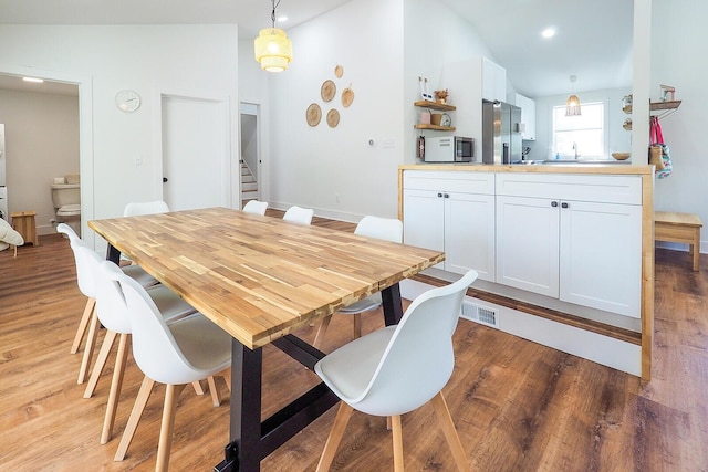 10671 California Rd, Bridgman, MI 49106 - dining space with light wood-type flooring, stairs, lofted ceiling, and recessed lighting