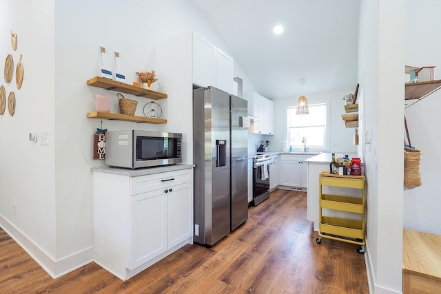 10671 California Rd, Bridgman, MI 49106 - kitchen with appliances with stainless steel finishes, open shelves, dark wood-style flooring, white cabinets, and lofted ceiling