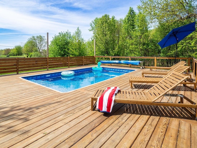10671 California Rd, Bridgman, MI 49106 - view of pool with a wooden deck and a fenced backyard