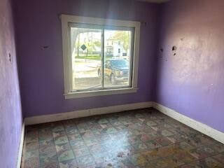 empty room featuring baseboards