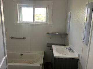 bathroom with vanity and a bath