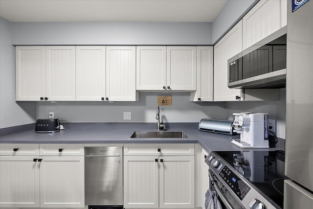 16046 Holz Dr Unit 48, Southgate, MI 48195 - kitchen featuring a sink, stainless steel appliances, and white cabinets