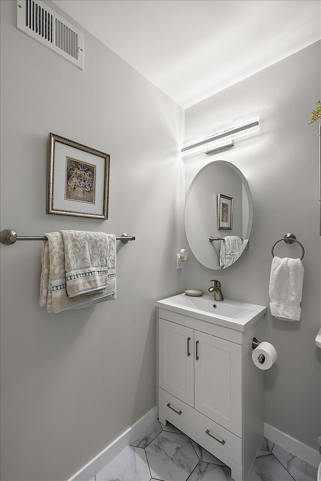 16046 Holz Dr Unit 48, Southgate, MI 48195 - bathroom with baseboards, marble look tiles, and vanity