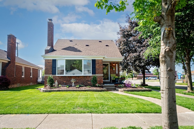 13185 Sycamore St, Southgate, MI 48195 - view of front of property with brick siding, a front yard, roof with shingles, and a chimney