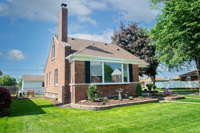 13185 Sycamore St, Southgate, MI 48195 - view of side of property with a chimney, brick siding, and roof with shingles