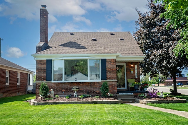 13185 Sycamore St, Southgate, MI 48195 - bungalow with brick siding, a front lawn, a chimney, a shingled roof, and central AC