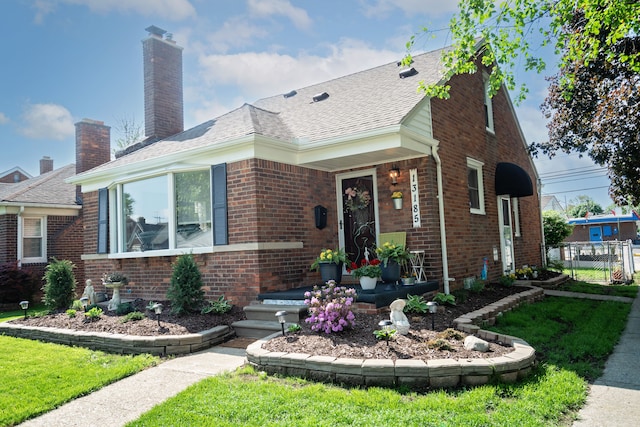13185 Sycamore St, Southgate, MI 48195 - view of front of property featuring brick siding, a chimney, and roof with shingles
