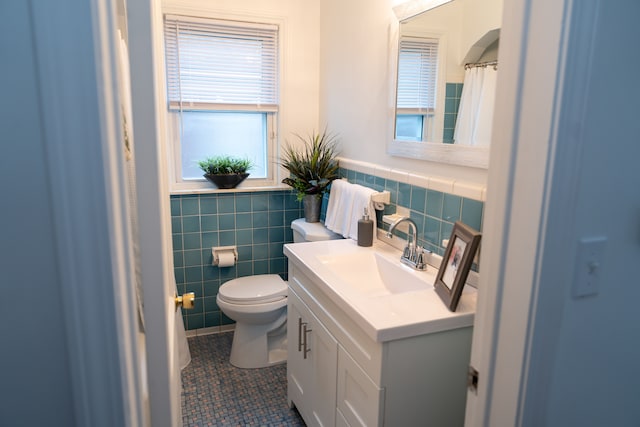 13185 Sycamore St, Southgate, MI 48195 - full bath with tile walls, toilet, tile patterned floors, vanity, and a wainscoted wall