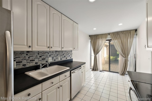1461 Woodglen Ln Unit G-28, Bloomfield Hills, MI 48304 - kitchen featuring stainless steel appliances, dark countertops, white cabinetry, and recessed lighting