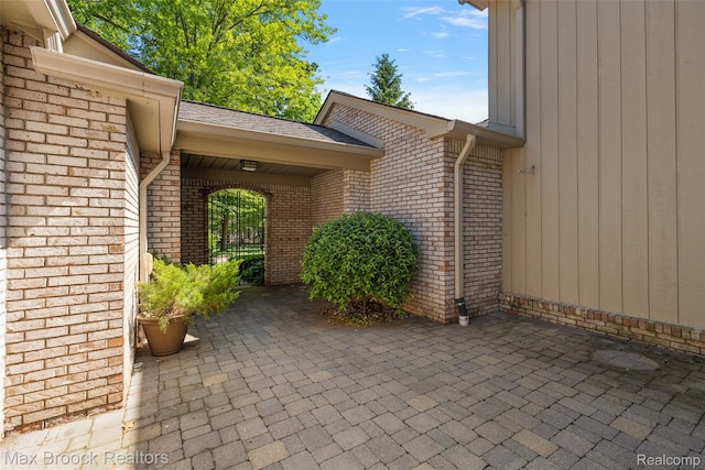 1461 Woodglen Ln Unit G-28, Bloomfield Hills, MI 48304 - view of exterior entry with brick siding and a patio area