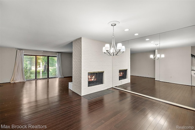 1461 Woodglen Ln Unit G-28, Bloomfield Hills, MI 48304 - unfurnished living room featuring a fireplace, a chandelier, wood finished floors, and recessed lighting
