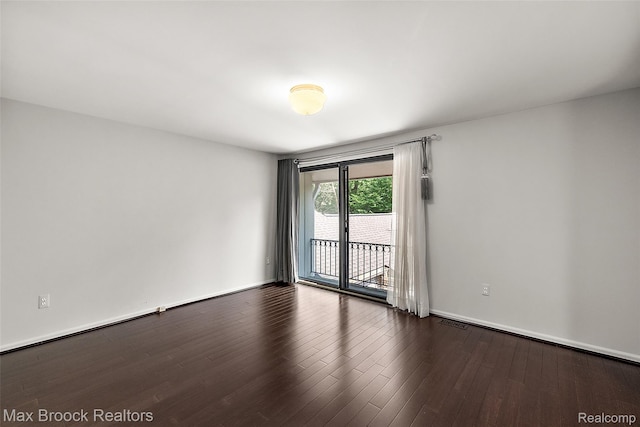 1461 Woodglen Ln Unit G-28, Bloomfield Hills, MI 48304 - spare room featuring wood finished floors and baseboards