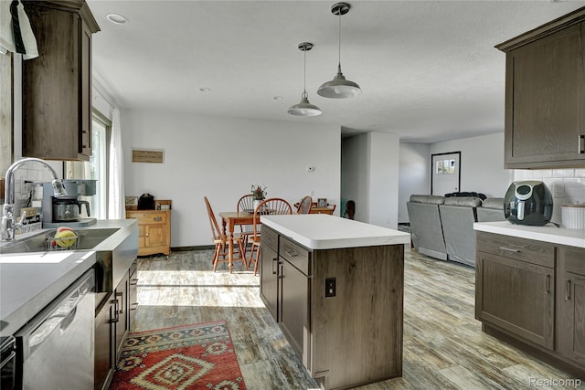 7376 Capac Rd, Yale, MI 48097 - kitchen featuring stainless steel dishwasher, a center island, light wood-style flooring, and dark brown cabinets