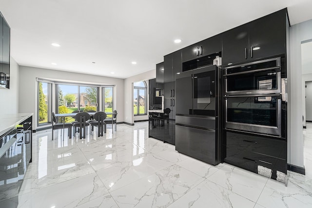 53242 Clarion Dr, Macomb, MI 48042 - kitchen with dark cabinetry, multiple ovens, modern cabinets, recessed lighting, and light marble finish floors